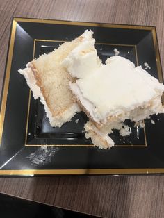 a piece of cake sitting on top of a black plate