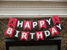 a happy birthday banner hanging from the side of a fireplace