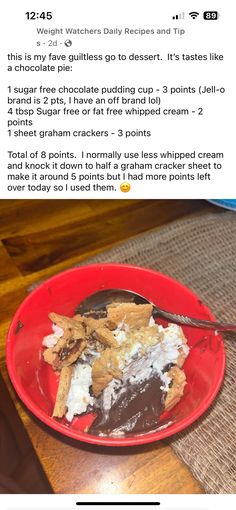 a red plate topped with food on top of a wooden table