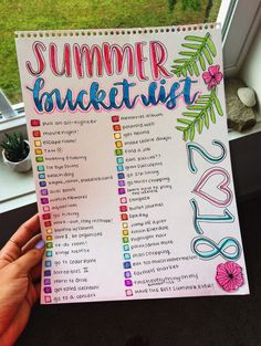 someone holding up a summer bucket list