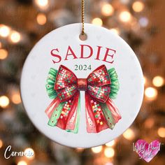 a personalized ornament hanging from a christmas tree