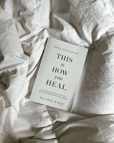 this is how you heal book laying on top of a bed with white linens