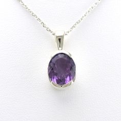 This genuine faceted 9x11mm oval amethyst gemstone in set in a sterling silver pendant setting. Pendant is 3/4 inch long and 3/8 inch wide and comes on an 18 inch long silver diamond cut cable chain. To clean: simply use a jewelry polishing cloth to brighten the silver when needed. Style Number: 16603 Metal: 925 Sterling Silver Gemstone: Genuine Amethyst Dimensions: 3/4 inch long and 3/8 inch wide, 18 inch chain Modern Oval Sterling Silver Gemstones, Faceted Oval Purple Jewelry, Faceted Oval Sterling Silver Necklaces, Oval Faceted Sterling Silver Necklaces, Oval Large Gemstones In Sterling Silver, Faceted Oval Sterling Silver Necklace, Oval Faceted Sterling Silver Necklace, Classic Oval Amethyst Necklaces, Classic Amethyst Oval Jewelry