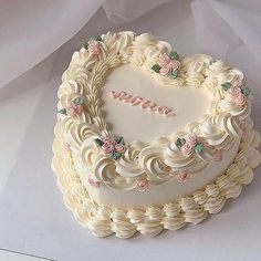 a heart shaped cake with flowers on it