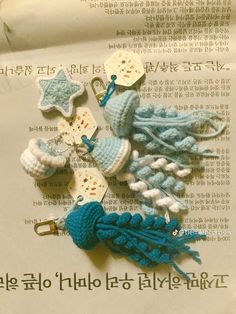 several crocheted items are laying on top of an open book with chinese writing in the background