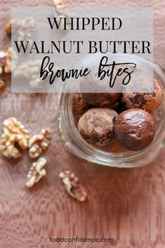 chocolate peanut butter brownie bites in a glass bowl with walnuts on the side