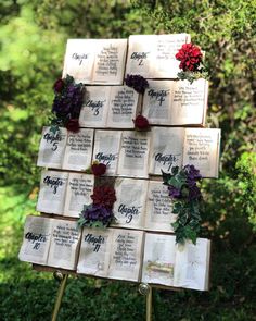 an arrangement of books with flowers on them are arranged in the shape of a tree