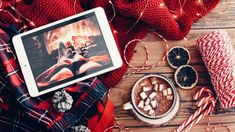 a tablet computer sitting on top of a table next to candy canes and christmas decorations