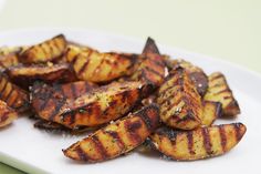 grilled potatoes on a white plate ready to be eaten