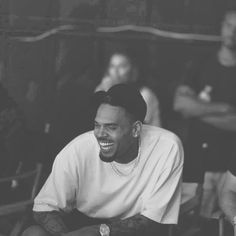 a black and white photo of a man smiling