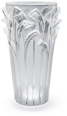 a clear glass vase sitting on top of a white table