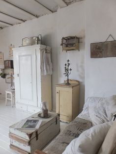 a living room filled with furniture and white walls