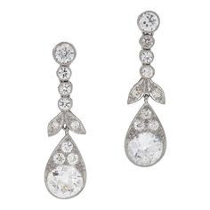 A pair of Edwardian platinum drop earrings with diamonds. The earrings have a delicate graduating drop of four stones and a delicate downward facing leaf motif garnishing the top of a dramatic tear drop housing a 2.00 carat Old European Cut diamond. The earrings have an approximately 5.5 carats of diamonds in total. Circa 1910. Yellow Gold Drop Earrings, Sapphire And Diamond Earrings, Diamond Cluster Earrings, Platinum Earrings, European Cut Diamonds, Antique Diamond, Fine Jewels, Antique Earrings, Diamond Drops