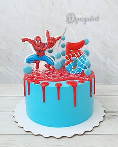 a spiderman birthday cake with red and blue icing