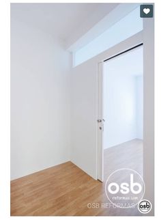 an empty room with white walls and wood floors is seen in this image from the doorway