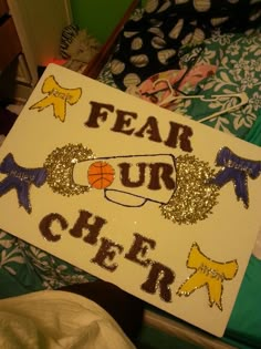 a sign that says fear our cheer with basketballs and bows on it's head