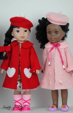 two dolls standing next to each other wearing red coats and pink shoes with hearts on them