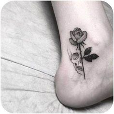 a small rose tattoo on the foot