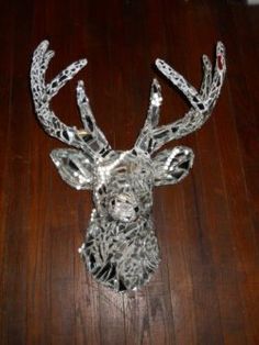 a metal deer head on a wooden floor