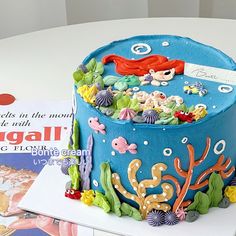 there is a blue cake decorated with sea creatures