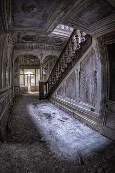 an old building with stairs and graffiti on the walls