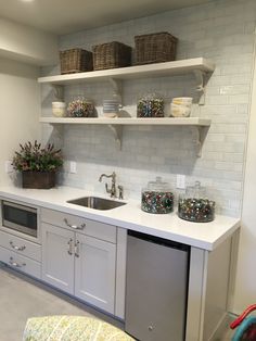 a kitchen with white cabinets and open shelves