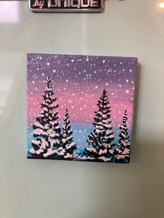 an acrylic painting of some trees in the snow on a refrigerator freezer