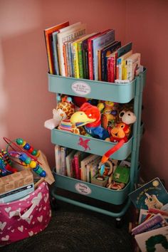 a toy storage unit with books and toys on it in a child's room