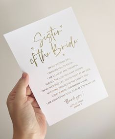 a person holding up a card that says sister of the bride with gold lettering on it