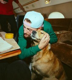 a man sitting at a table with his dog