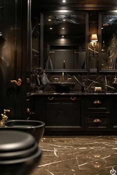 a bathroom with two sinks, mirrors and lights on the wall in it's dark color