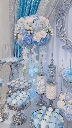 a table topped with lots of blue and white desserts