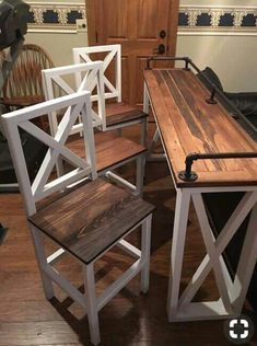 three wooden chairs sitting on top of a hard wood floor