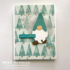 a close up of a christmas card with a gnome on the front and snowflakes in the back