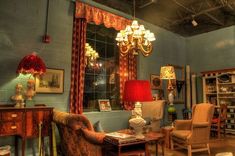 a living room filled with furniture and a chandelier