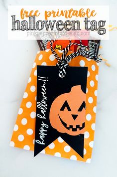 an orange and black trick or treat bag with a jack - o'- lantern tag