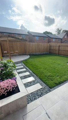 a backyard with grass and stepping stones