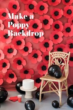 a chair sitting in front of a red and black wall with poppies on it