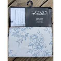 the lauren bedding set in blue and white is shown on a wooden floor with it's packaging