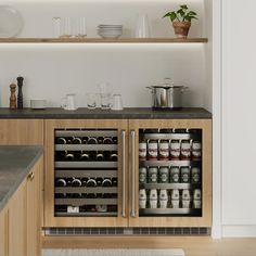 an open wine cooler in the middle of a kitchen