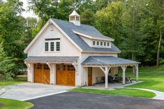 a two car garage with an attached porch