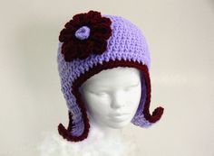 a crocheted hat on top of a white mannequin's head