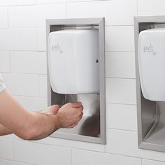 a man is holding his hand out to someone using the urinal on the wall