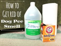 a bottle of dog pee smell sitting next to a box of baking soda and a roll of toilet paper