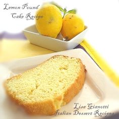 a loaf of bread sitting on top of a white plate next to two lemons