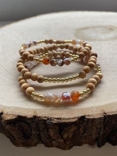 Our PUMPKIN SPICE stack! These are super stylish, comfortable and perfect for FALL! Such a trendy boho-look! (These are meant to fit snug. If you would like them to feel loose and move around on your wrist, please size up). Each bracelet is carefully handmade with high quality materials: -6mm natural Agate stones in Fall colors -6mm natural wood beads -3mm gold hematite beads -7mm black/gold acrylic letters -Cord: high-quality, durable, stretch cord with reinforced knots and specialty glue ⭐️⭐️W Gold Bracelets With Wooden Beads For Healing, Handmade Natural Wood Beaded Bracelets, Casual Gold Beaded Bracelets With Gemstone, Handmade Agate Beaded Bracelets For Everyday, Everyday Handmade Agate Beaded Bracelets, Spiritual Adjustable Natural Wood Beaded Bracelets, Adjustable Agate Jewelry With Wooden Beads, Handmade Agate Bracelets For Everyday, Everyday Beaded Agate Bracelets