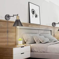 a bedroom with a bed, night stand and two lamps