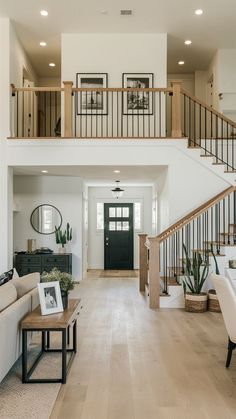 a living room filled with furniture and a staircase