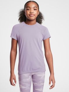 FOR: School, practice and play FEEL: Non-chafing seamless fabric is stretchy and comfortable FAVE: Keeps her comfy for all activities We make this for women too, check it out here Skims easily over the body. Seamless Stretch Tops For Light Sports, Stretch Seamless Tops For Light Sports, Purple Sporty T-shirt For Workout, Purple Moisture-wicking Training Tops, Sporty Stretch Purple T-shirt, High Stretch Seamless Tops For Light Sports, Stretch Purple T-shirt For Sports, Purple Seamless Tops For Gym, Purple Seamless Workout Tops