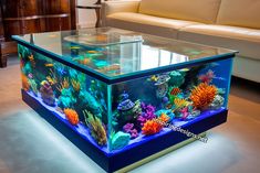 a fish tank is sitting on the floor in front of a couch and coffee table